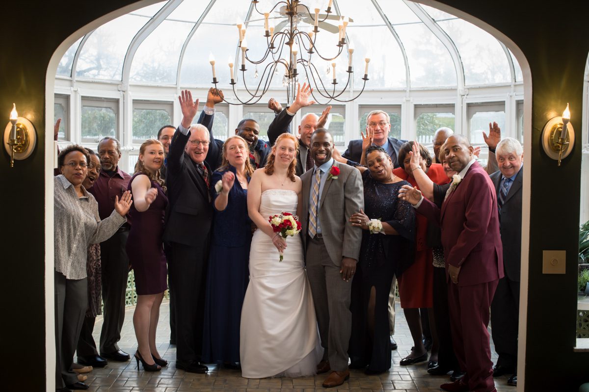 Winter Wedding at Tarrywile Mansion family photo in conservatory with everyone cheering