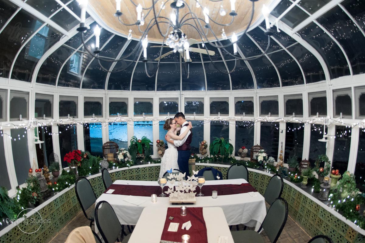 A Magical Wedding couple-holding-each-other-in-glass-conservatory-for-christmas-wedding