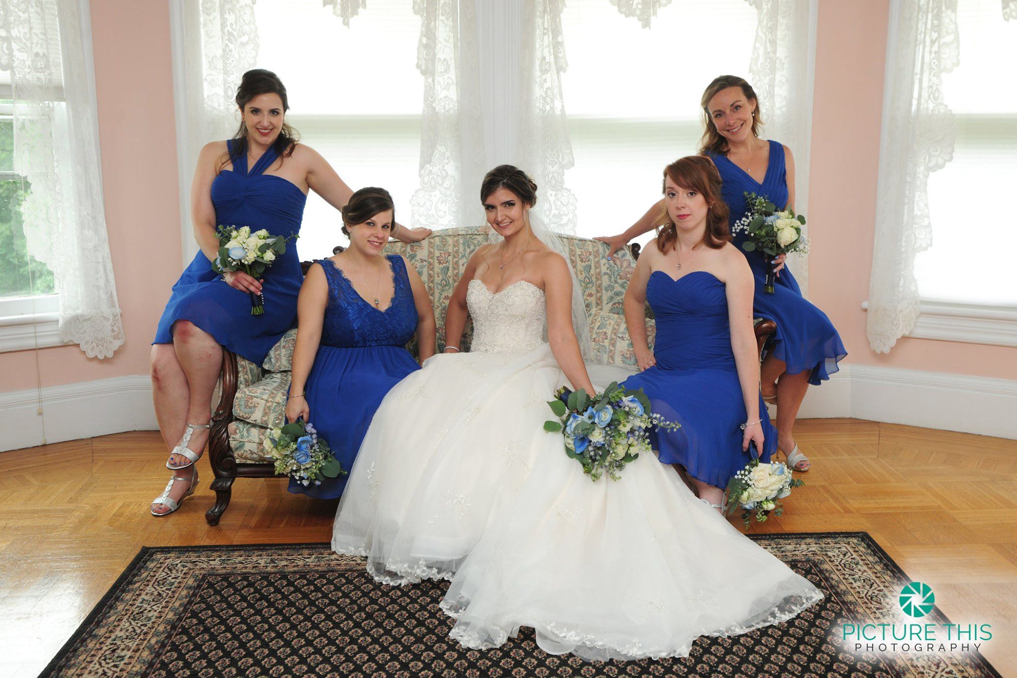 Classic June Wedding Moment late-june-wedding-party-bride-sitting-with-bridesmaids