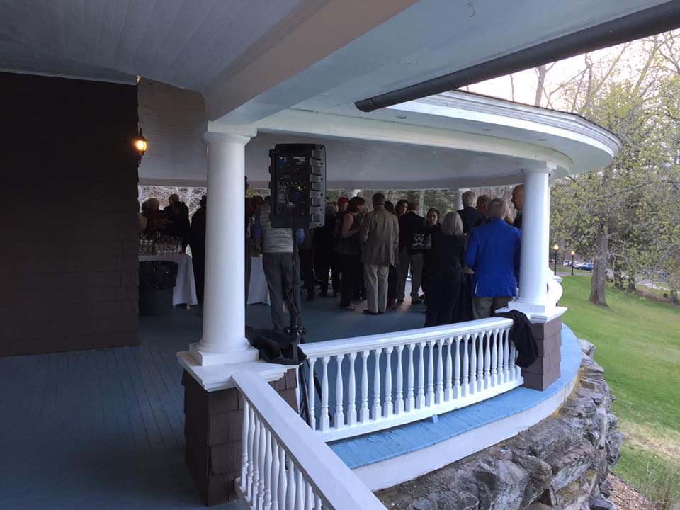 veranda with guests gathered around