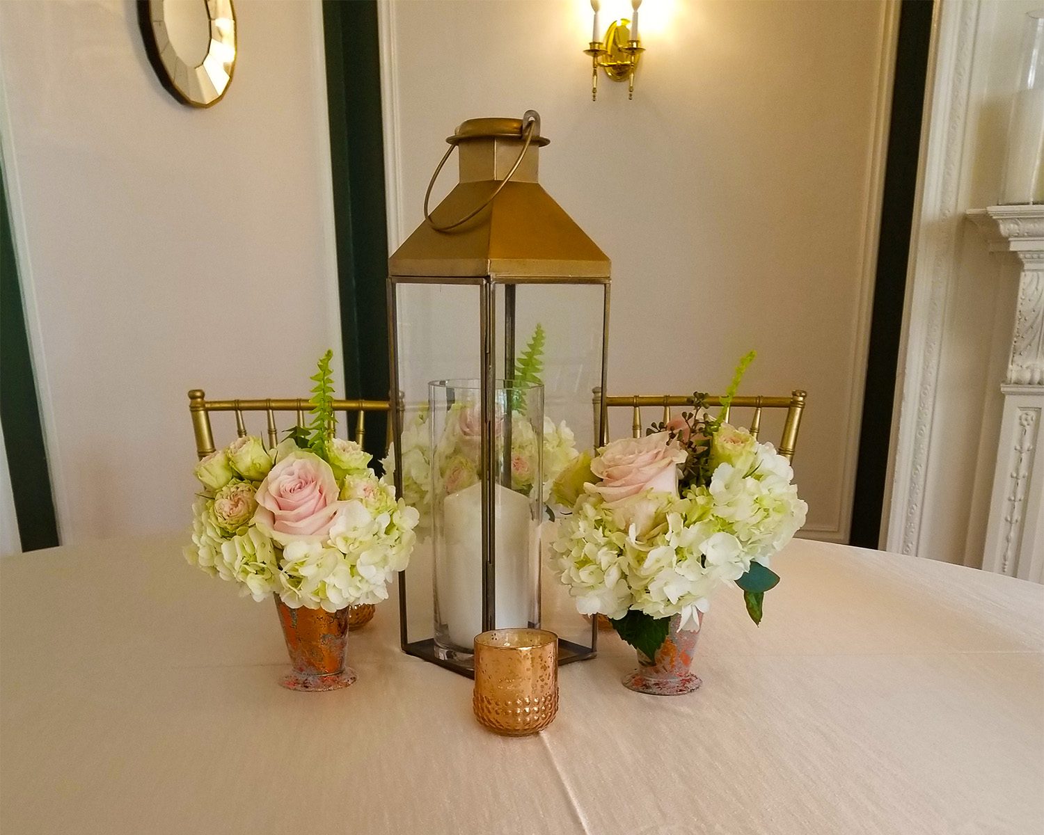 Events at Tarryrwile Mansion lantern with roses centerpiece on table